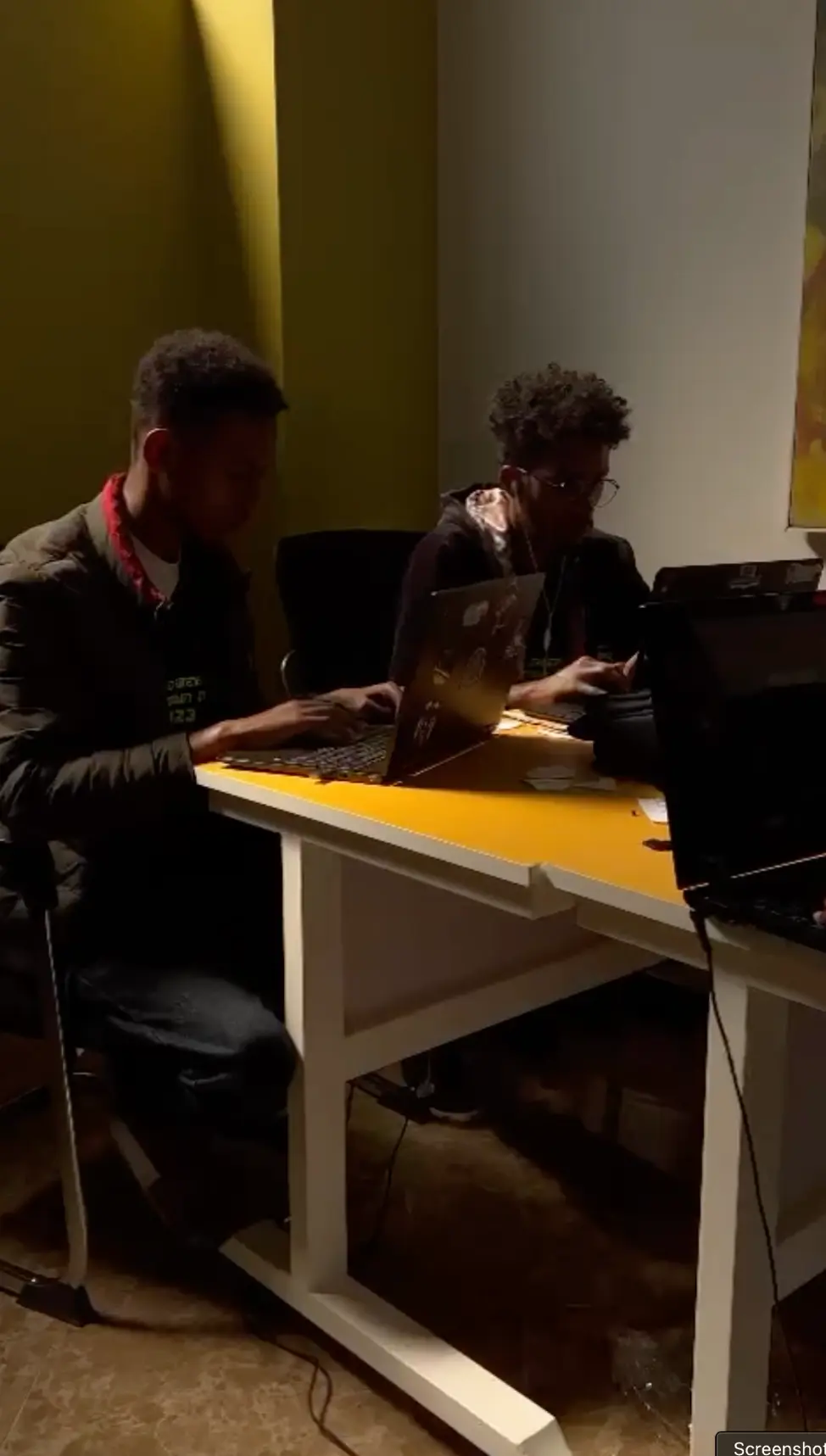 Two CyberShield participants focused on their laptops in 2023
